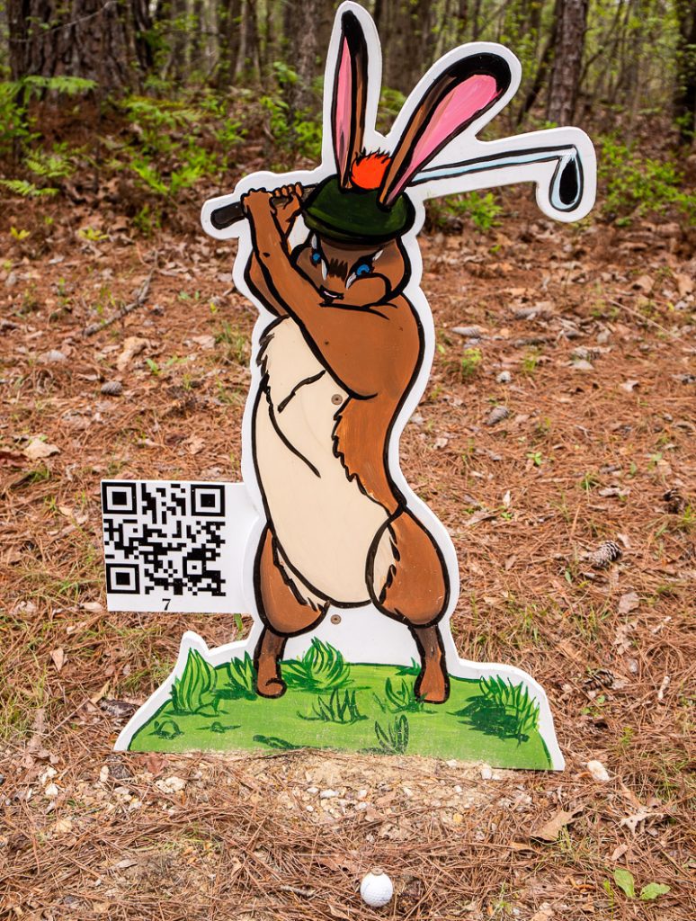 Cardboard cutout of a rabbit playing golf