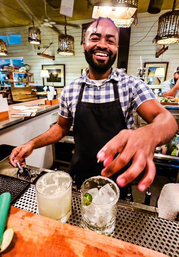 Bartender making cocktails and laughing