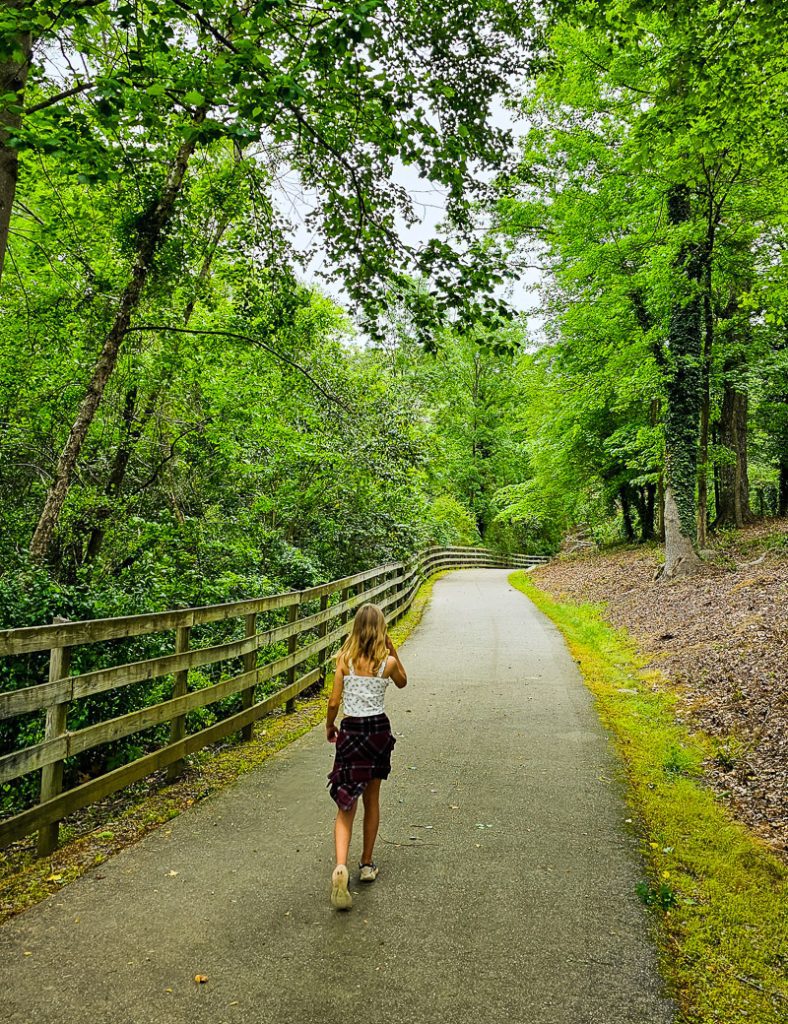 Girl walking a Greenway trail