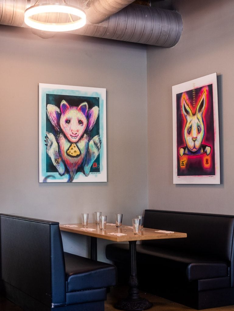 Booth and two paintings in a restaurant