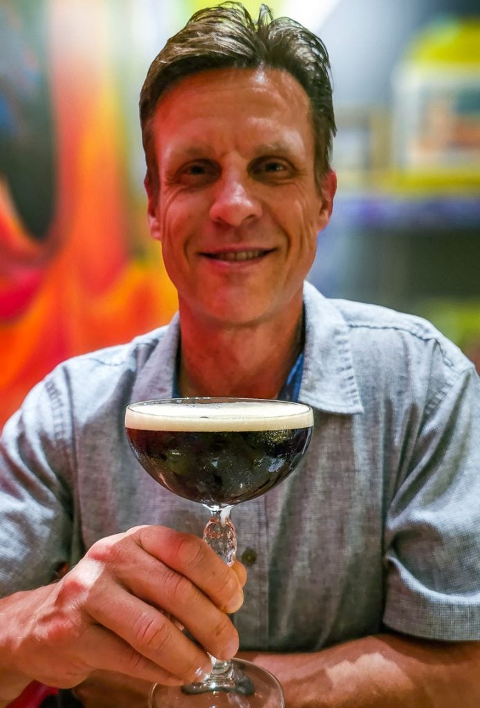 Man holding a glass of Espresso Martini