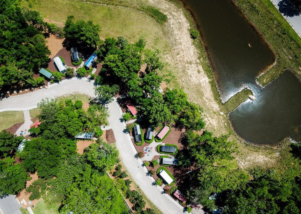 Aerial view of a tiny home community among trees