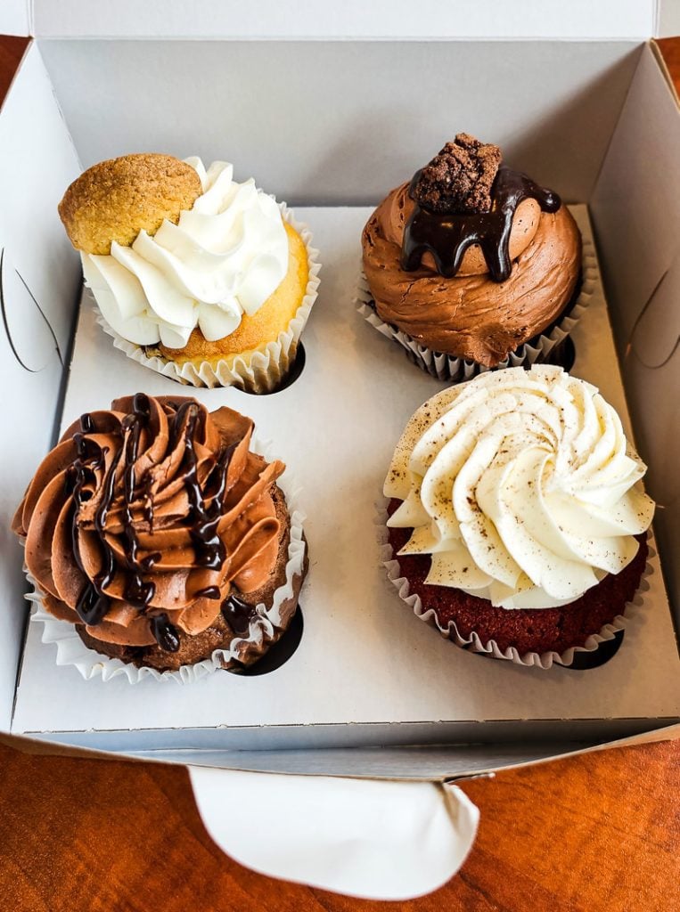Four cupcakes in a cardboard box