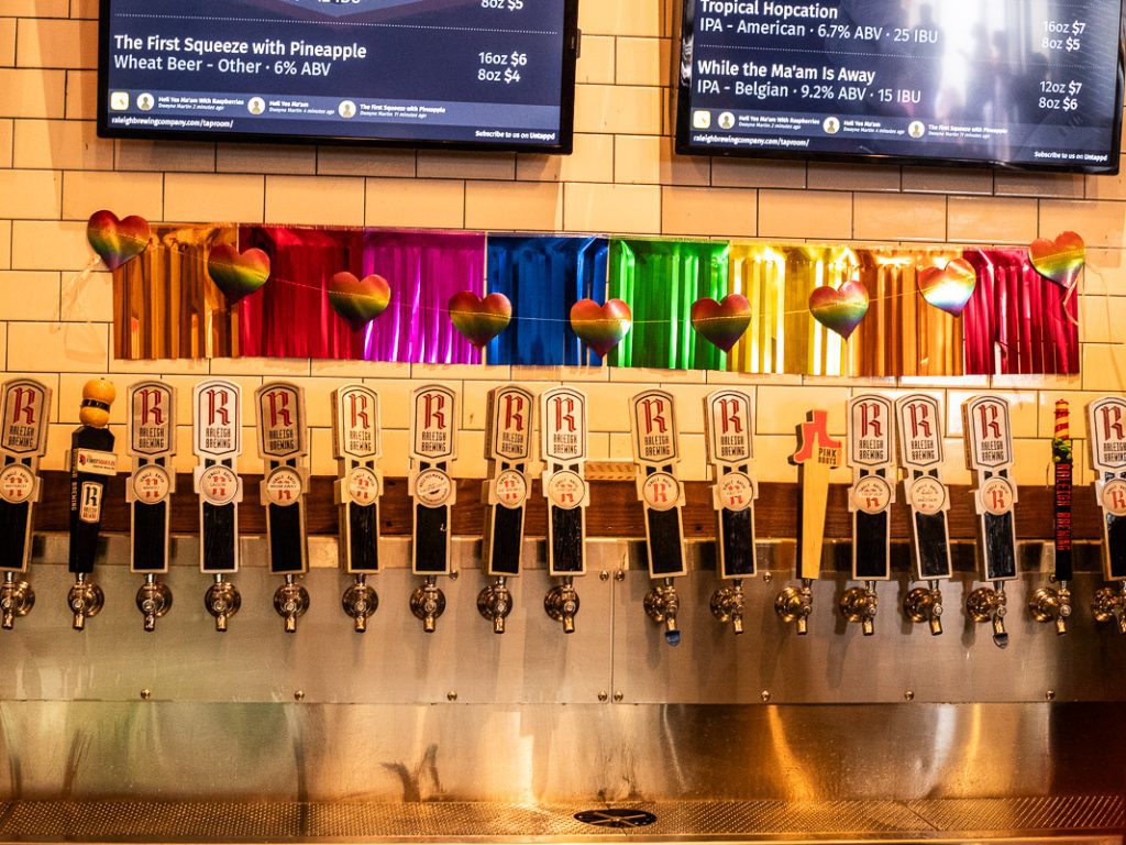 A row of beer taps on a wall