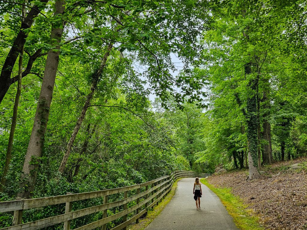 Girl walking along a greenway trail