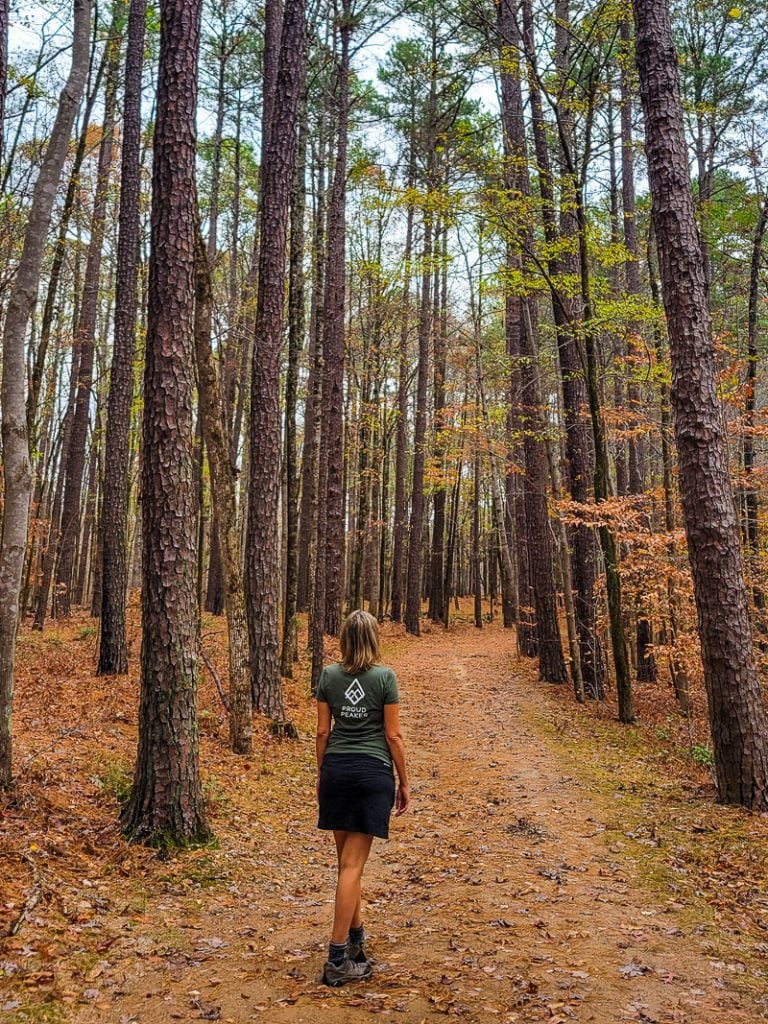 Woman walking along a nature trail in the woods