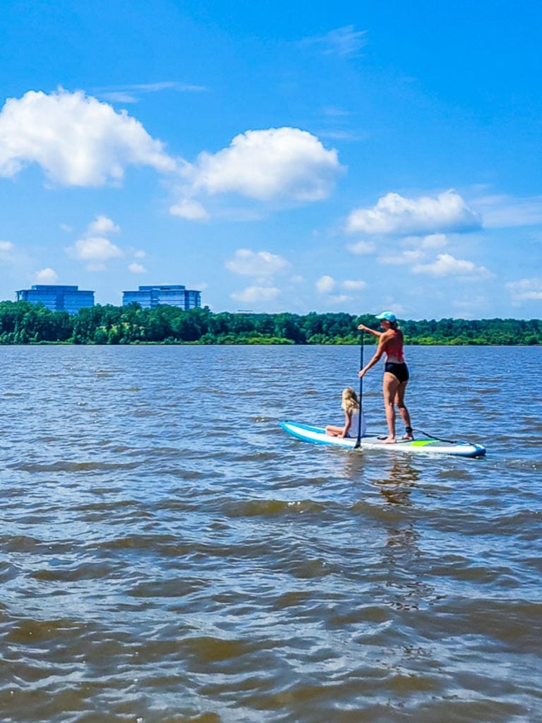 Mom and daughter on a stand up paddle board
