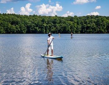 Man on a stand-up paddle board on a lake
