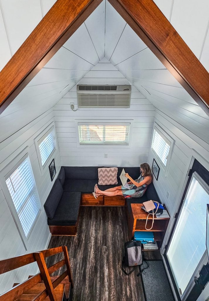 Lady sitting on a couch inside a tiny home