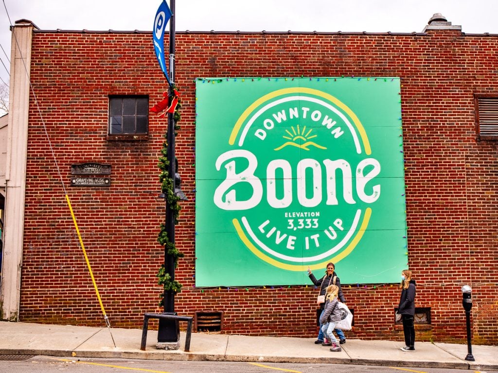 Mural on a brick wall that says downtown Boone