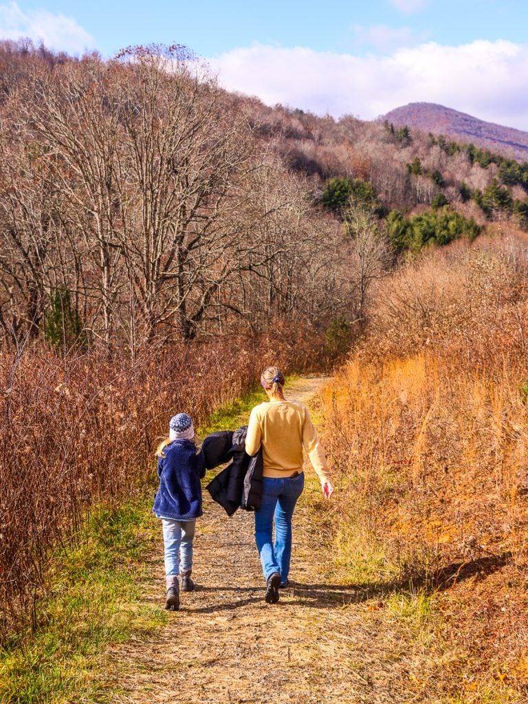 Mom and daughter walking a nature trail in the mountains of Boone, NC