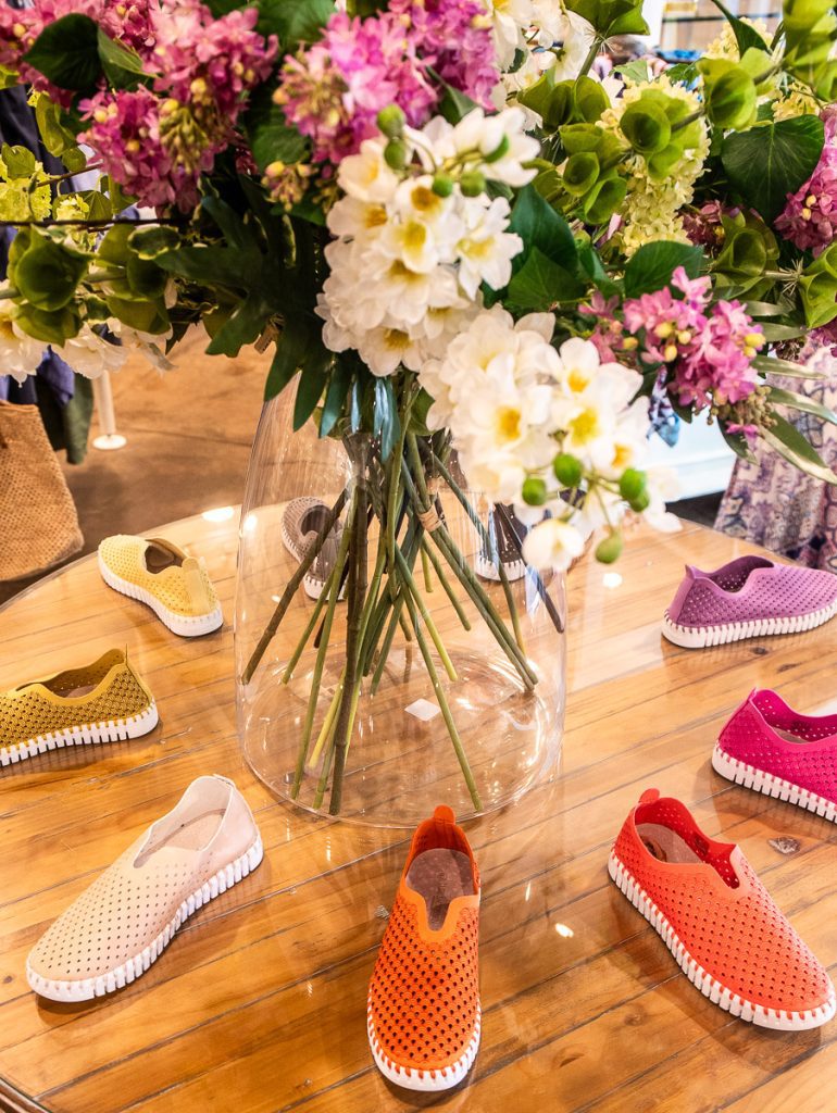 Shoes and flowers on a table on display