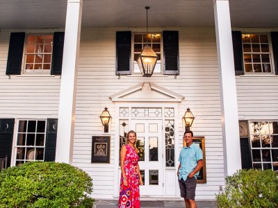 Man and woman standing in front of a Southern historic building