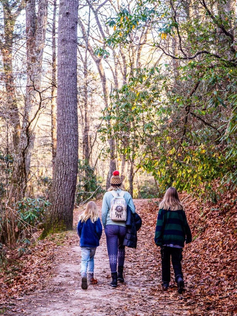 Mom and two daughters walking a nature trail