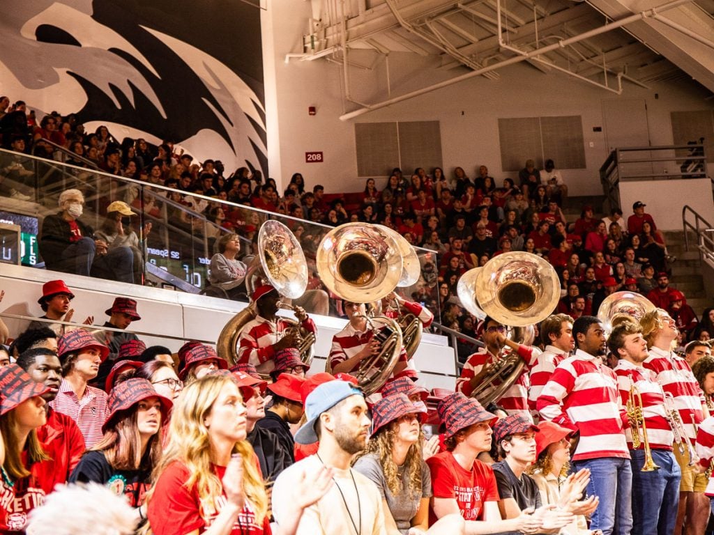 Fans and the school band at a basketball game