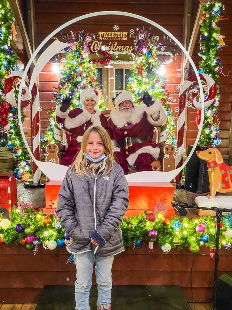 Girl in front of a Santa display