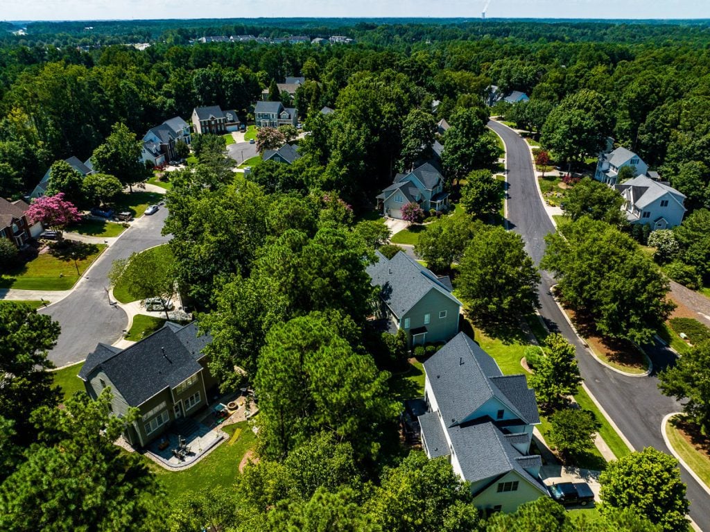 Aerial view of neighborhood homes with trees