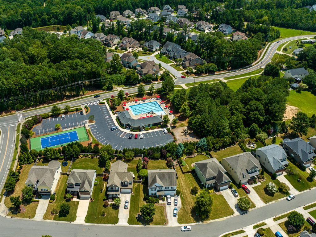 Aerial view of a neighborhood with homes and a pool