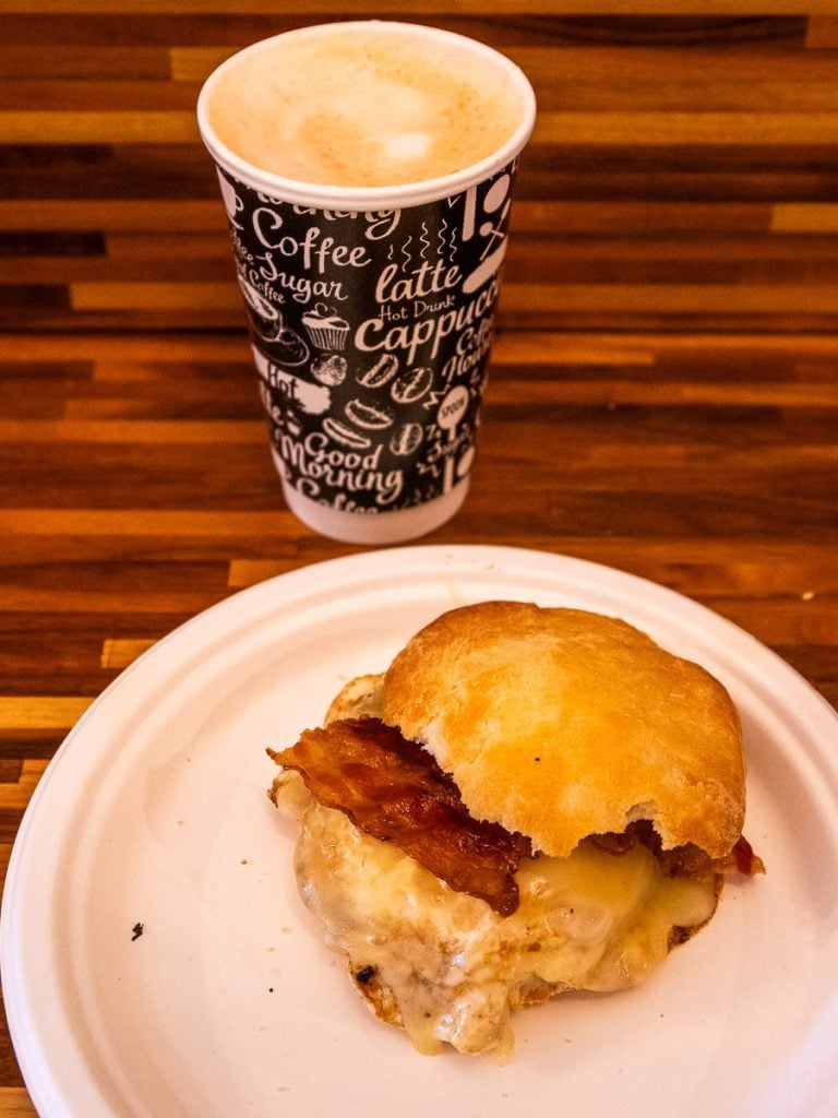 Bacon and egg biscuit with a cup of coffee