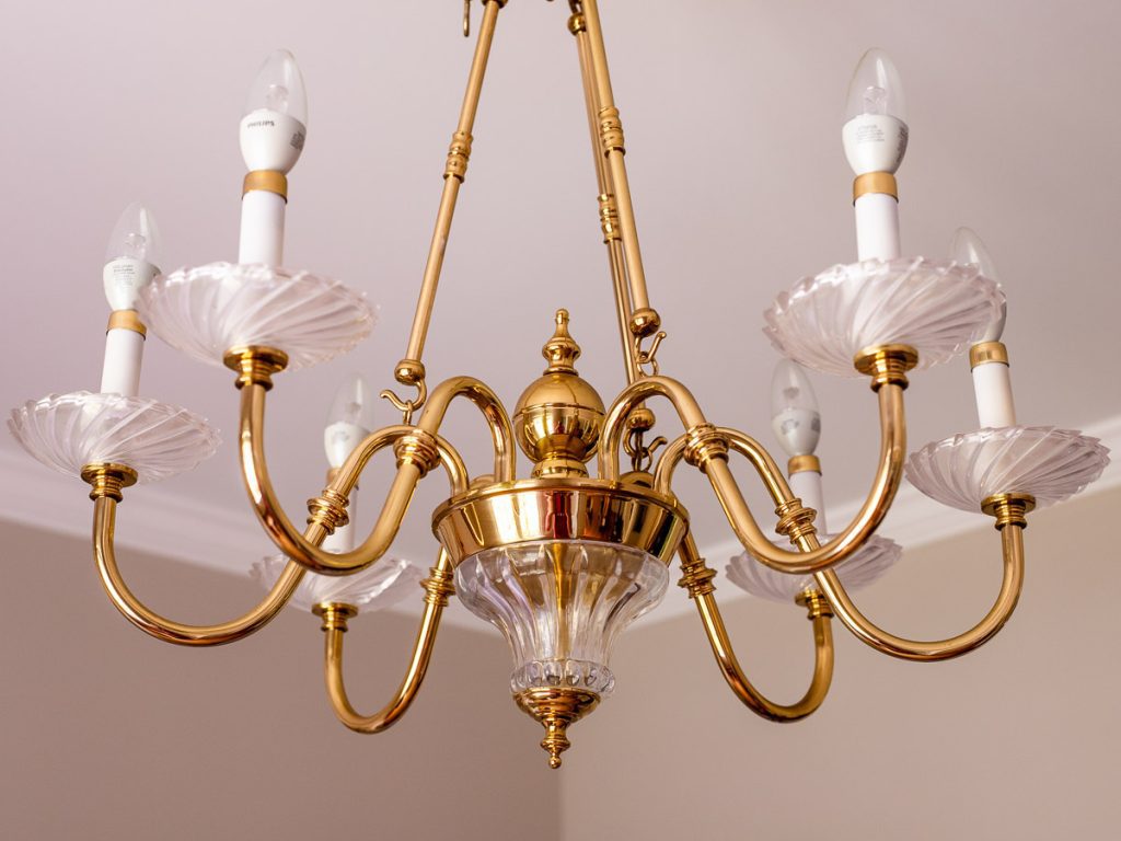 Gold chandelier hanging from ceiling
