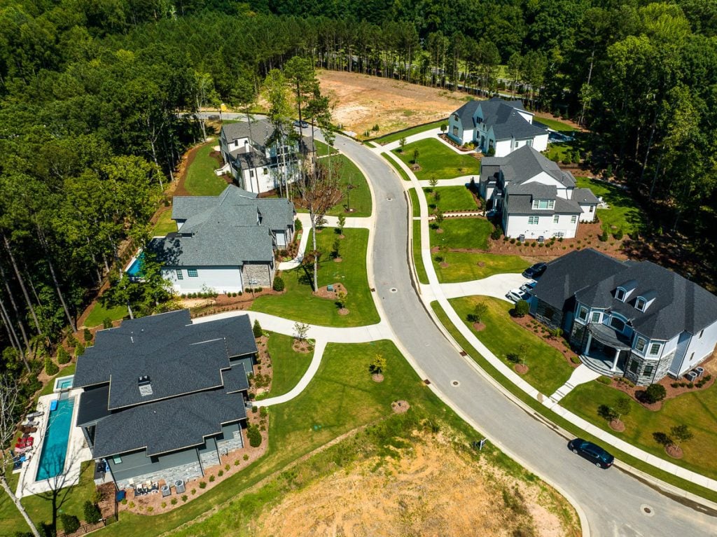 Aerial view of neighborhood homes and street