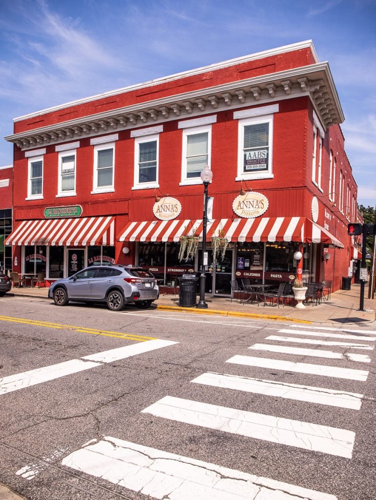 Crosswalk and a red brick building with an Italian restaurant