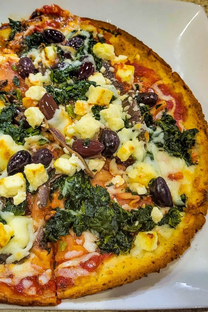 Pizza with olives and spinach