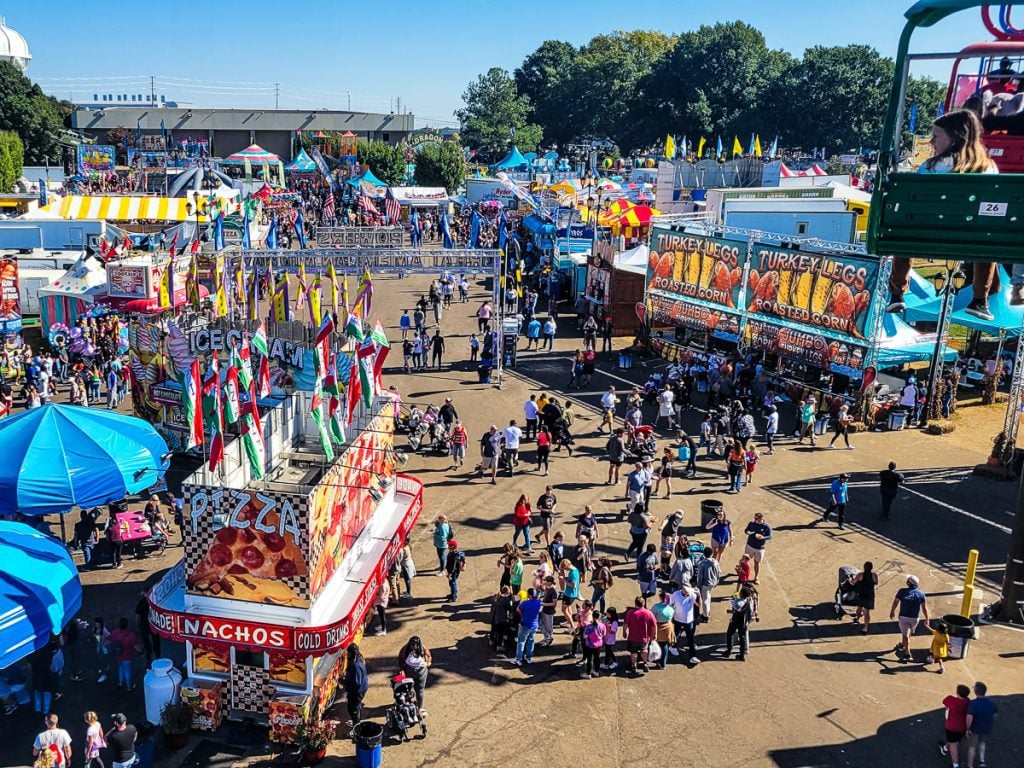 Rides and people at a festival