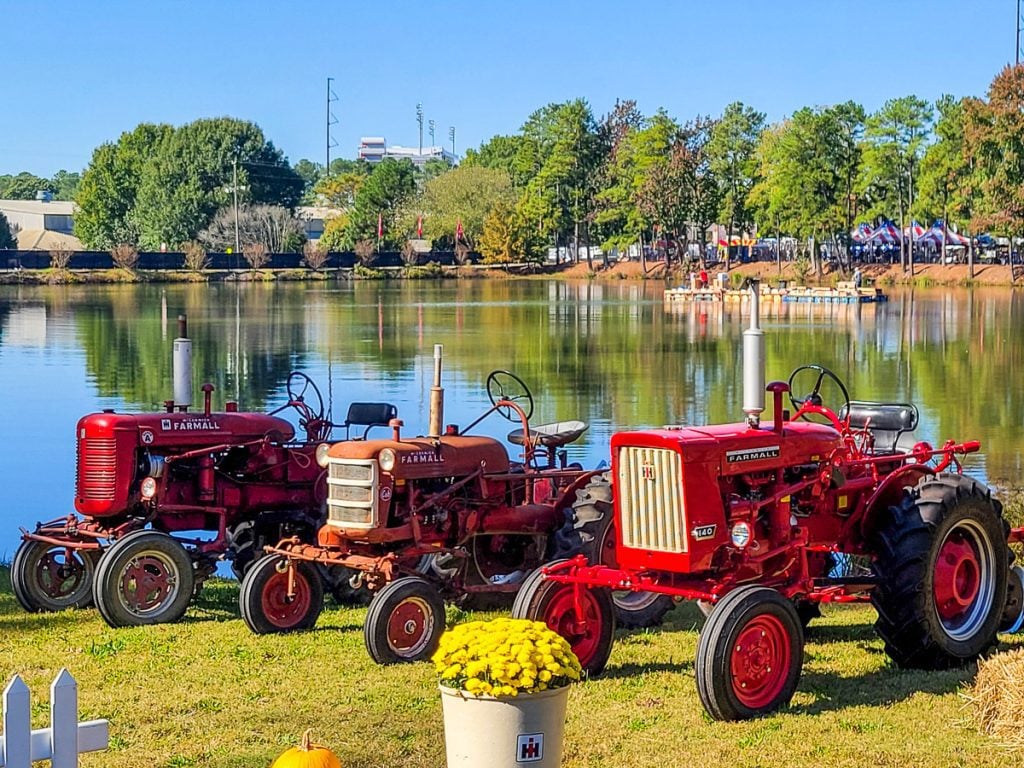 Row of tractors by a lake