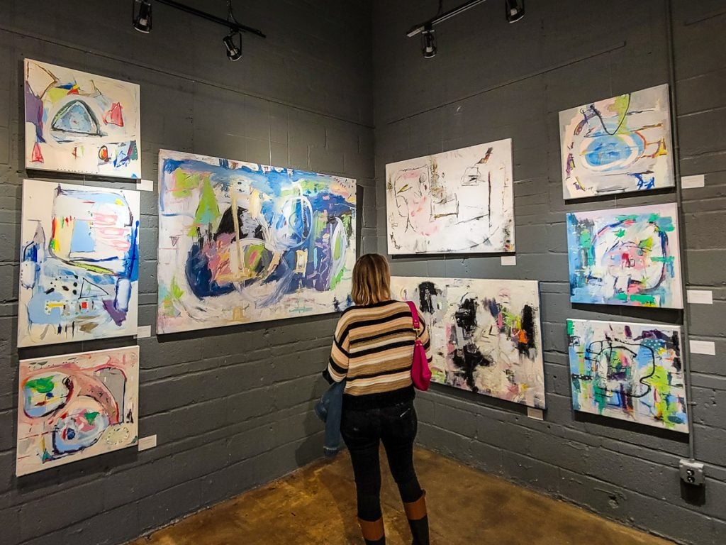Woman at an art gallery looking at art