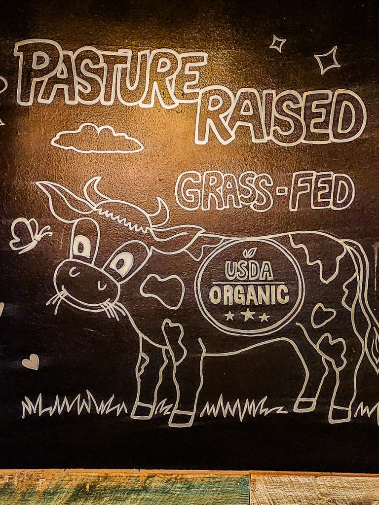Sign saying pasture raised grass fed beef.
