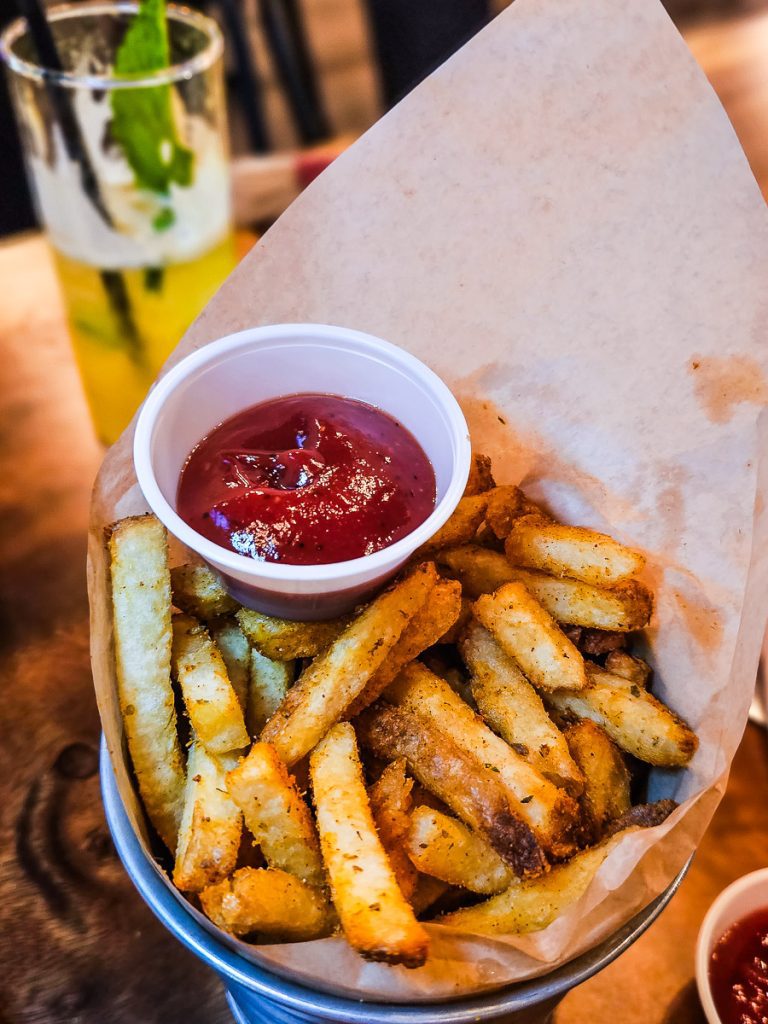 Bucket of fries and ketchup.