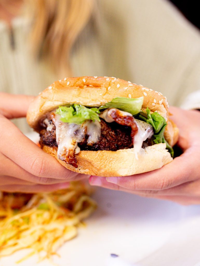girl holding burger