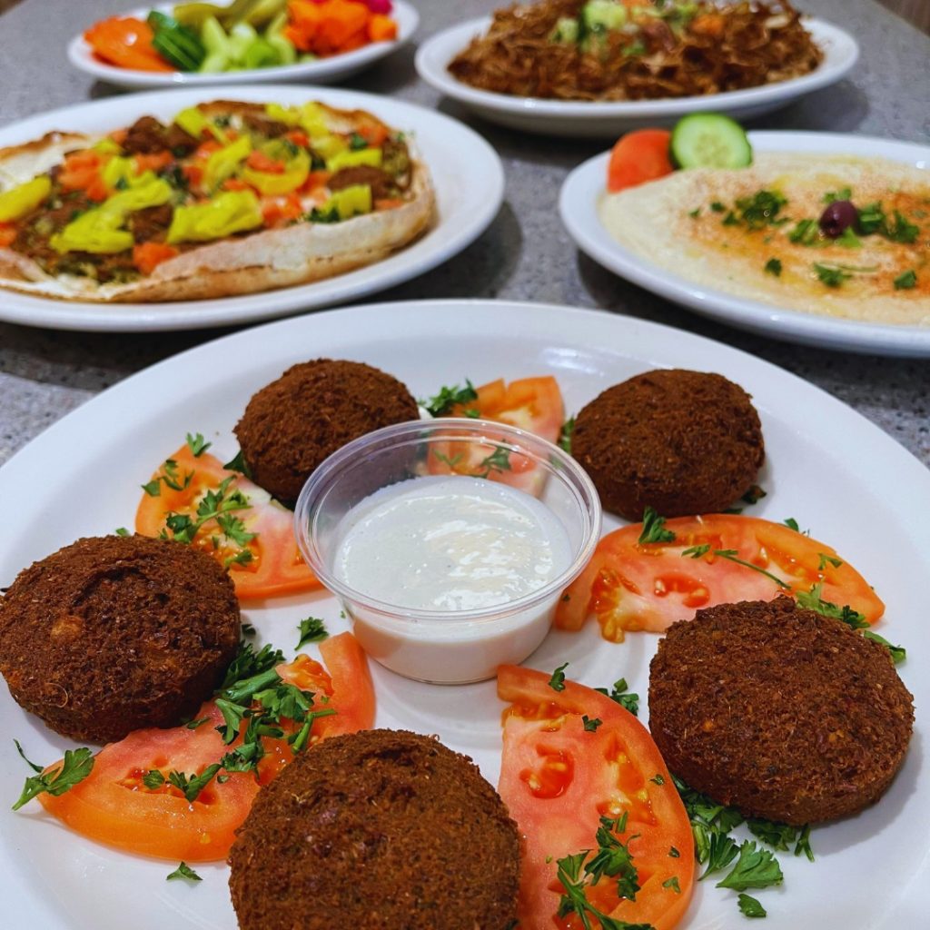 Falafel and tomatoes on a plate.