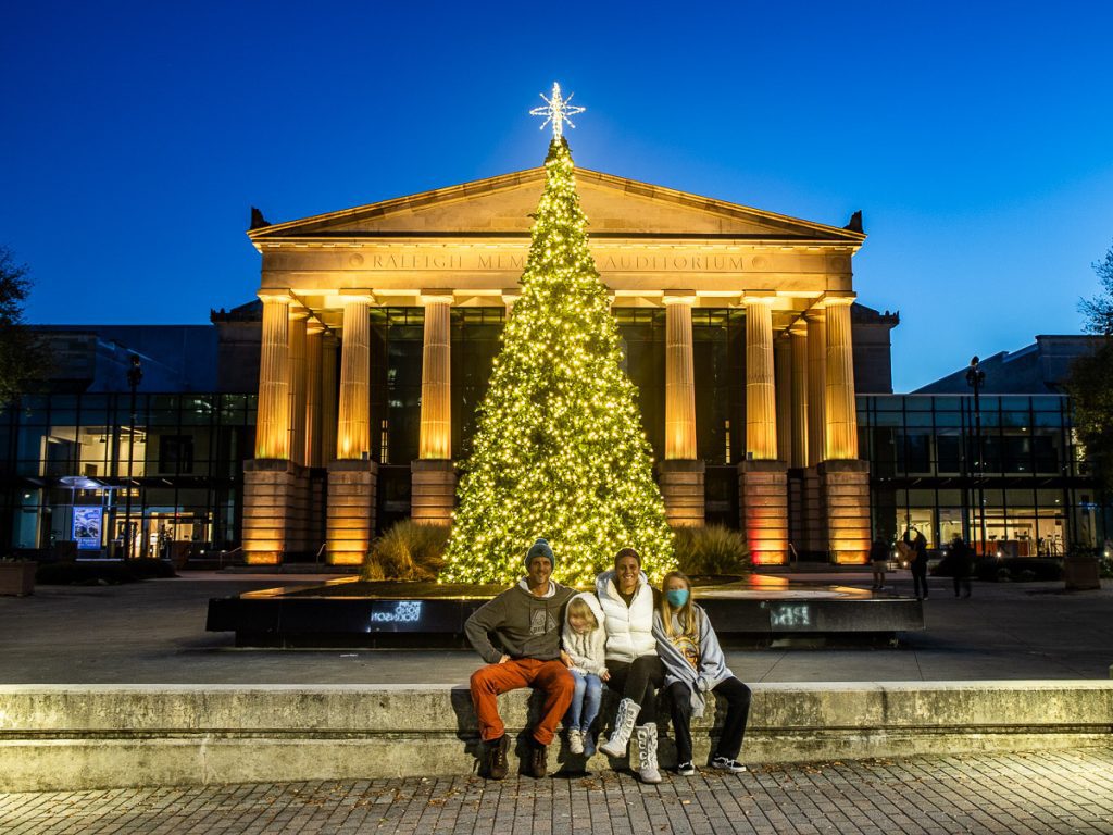 Family of four in front of a Christmas tree in Raleigh, North Carolina