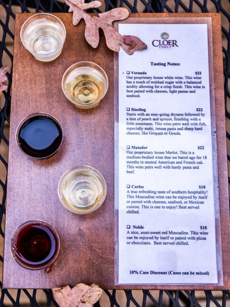 5 samples of wine on a board.