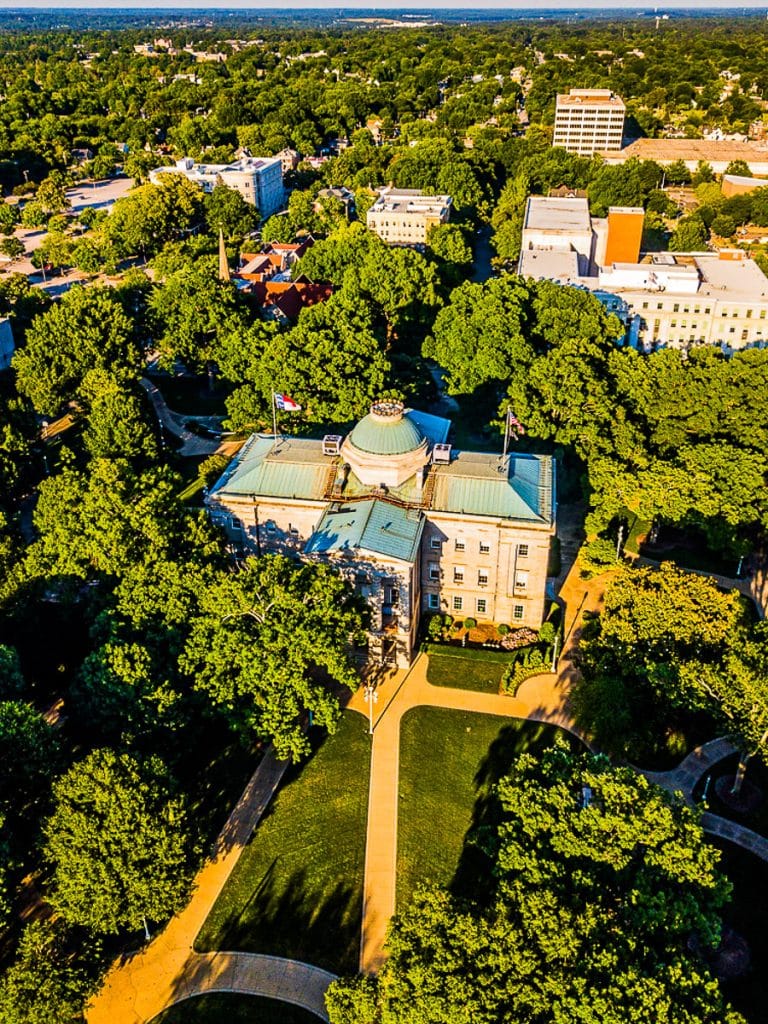 aerial view of Raleigh state capitol surrounded by trees.