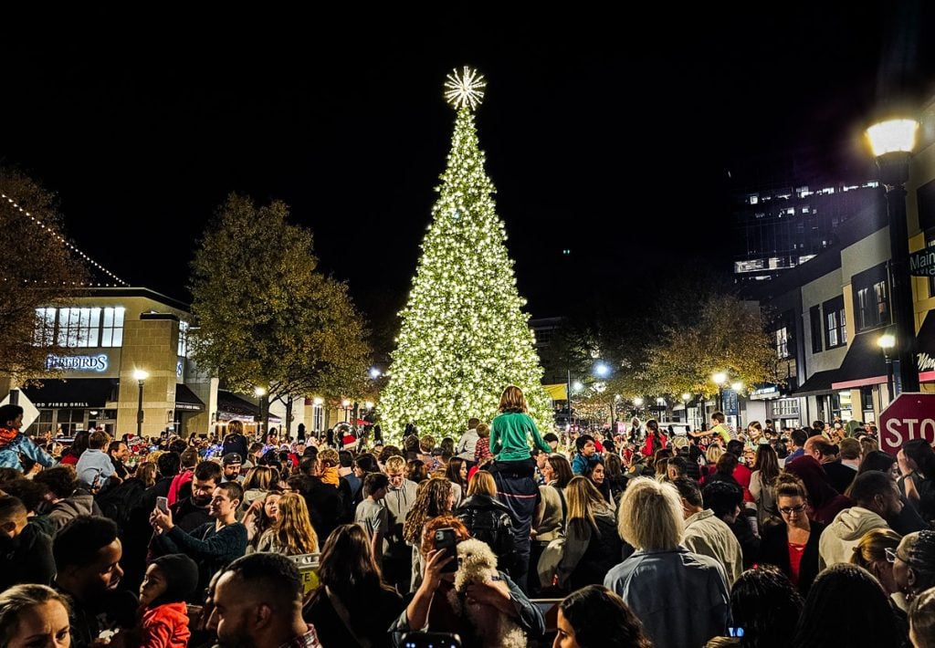 People at the lighting of a Christmas tree in North Hills, Raleigh.