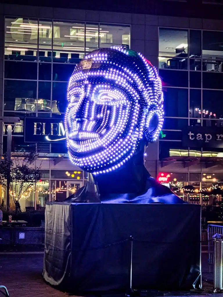 sculptured head illuminated by colored lights