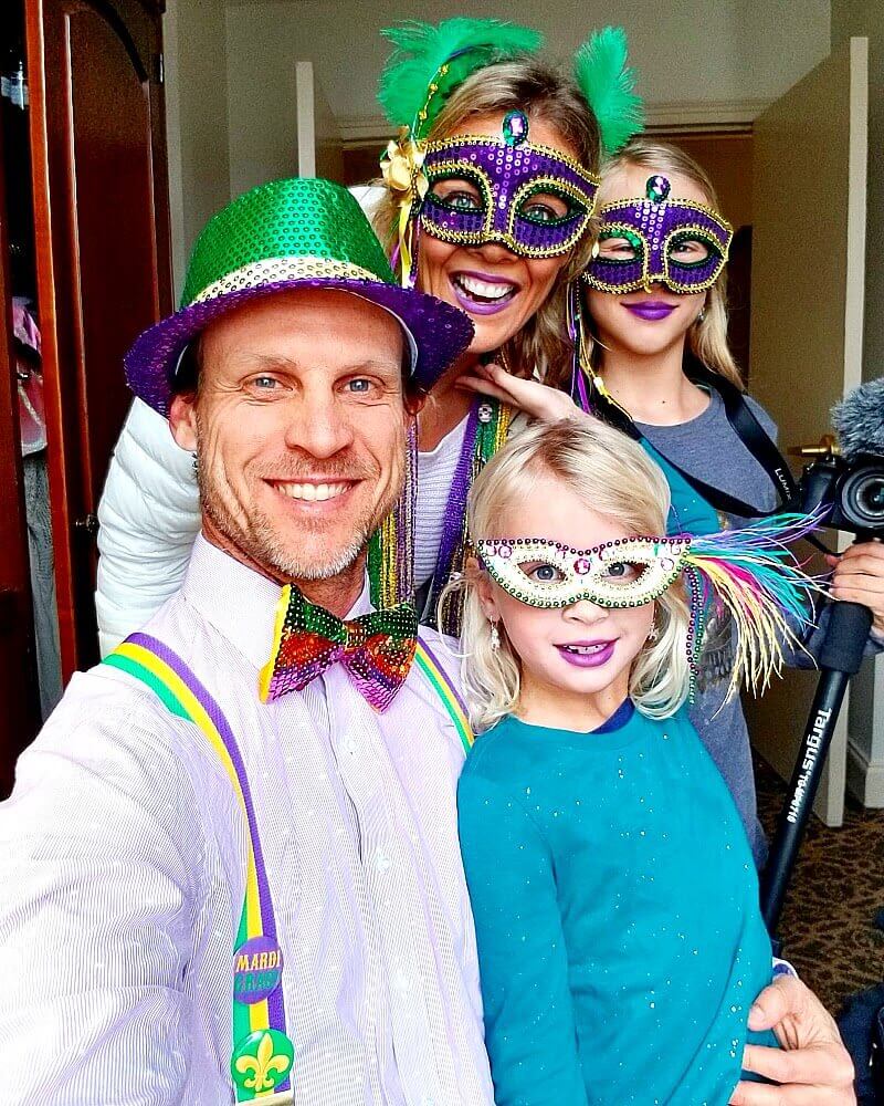 Family of 4 dressed in costumes for Mardi Gras in New Orleans.