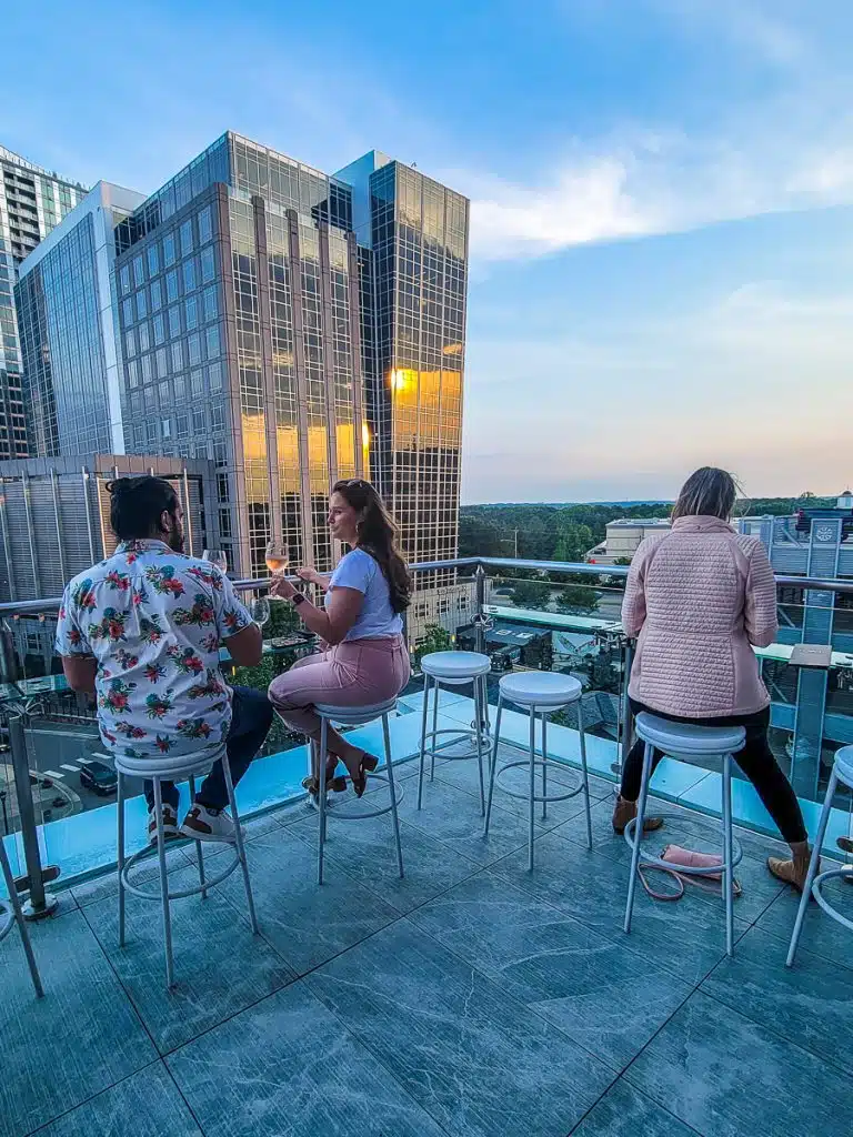 People drinking on a rooftop bar.