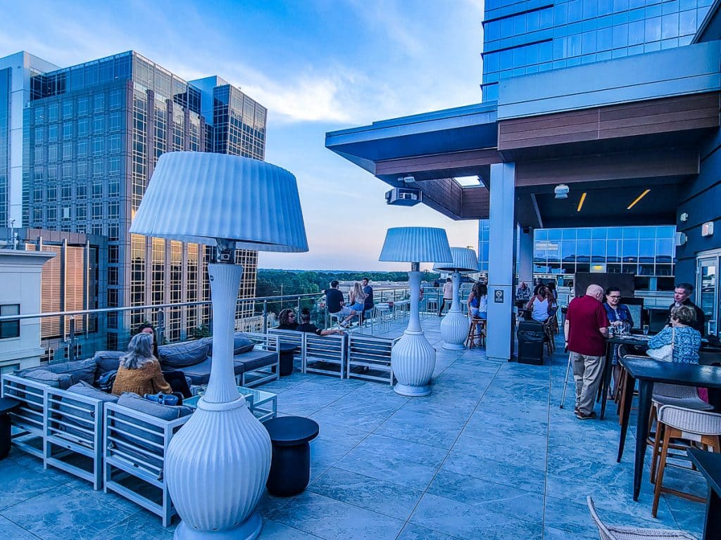 People drinking on a rooftop bar.