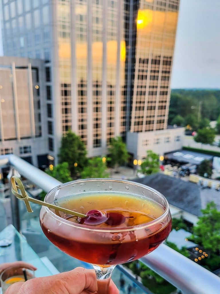 Cocktail with a building behind it.