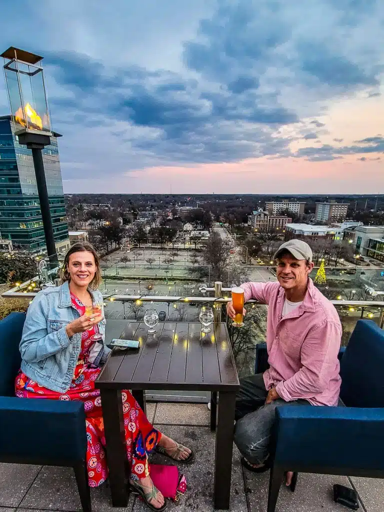Man and woman having a drink on a rooftop bar.