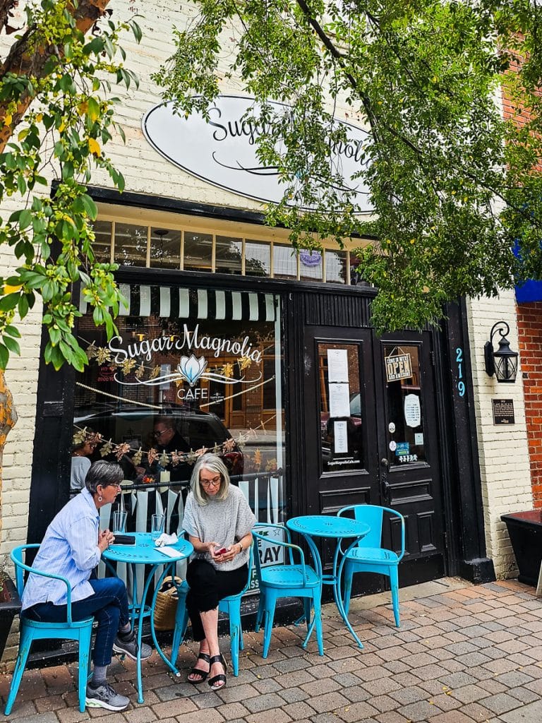 Two women sitting outside a cafe.