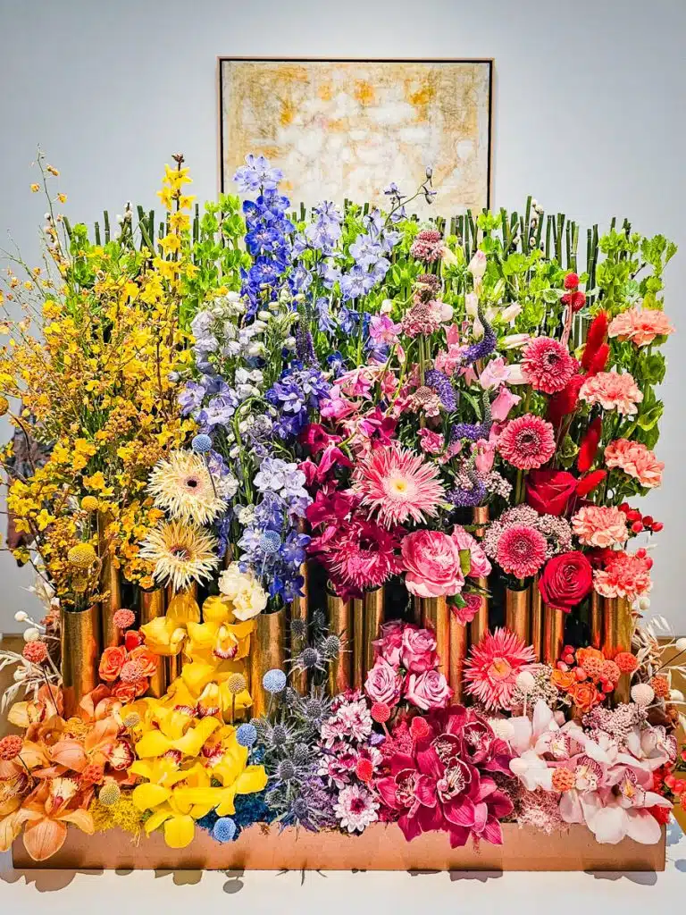 rainbow floral arrangement in art gallery