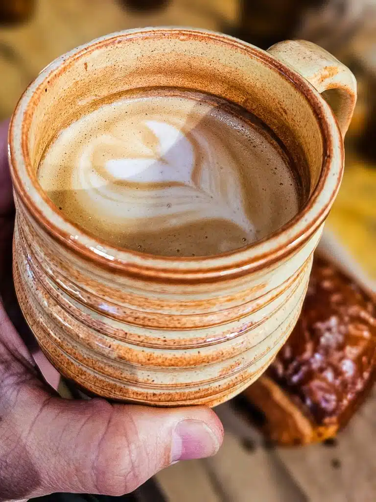 Mug of coffee in a hand.