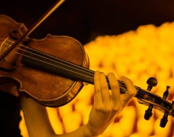 violin surrounded by candles