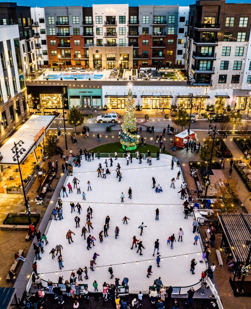 Ice skating rink outside at a shopping mall.