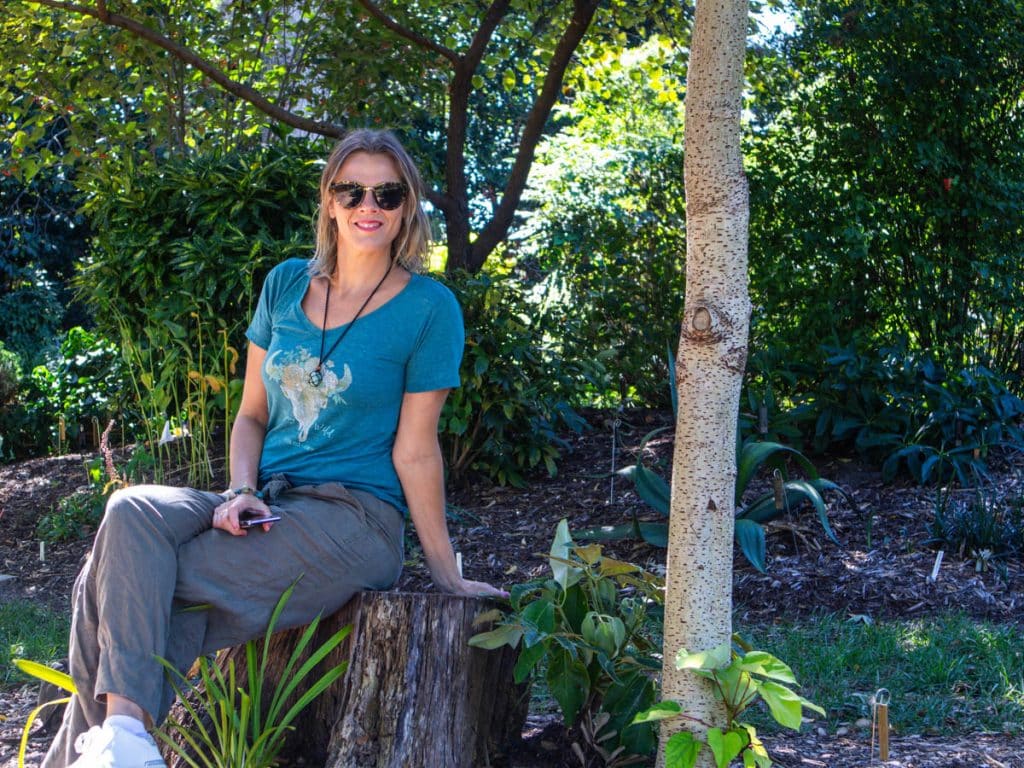 woman sitting on bench in juniper garden